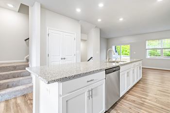 Evolv at stonehaven townhomes in white plains, maryland kitchen with island and dishwasher